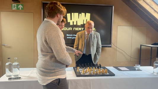 Participants engaged around a smart chessboard during the Chess & Mates event in Belgium.