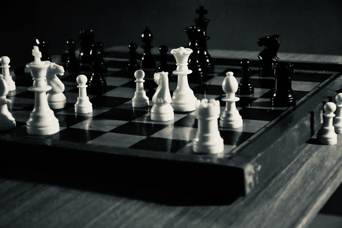 Chess board with pieces illustrating recurring mistakes that stall your chess progress.