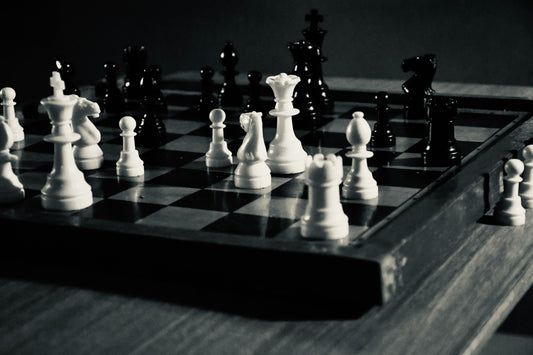 Chess board with pieces illustrating recurring mistakes that stall your chess progress.