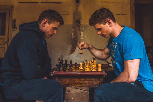 Two players focused on breaking through their chess plateau during an intense game of chess.